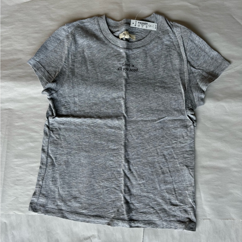 Grey t-shirt with “Love is all you need”